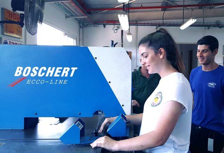 a student practices Boschert punching and forming machine at the technological educational center