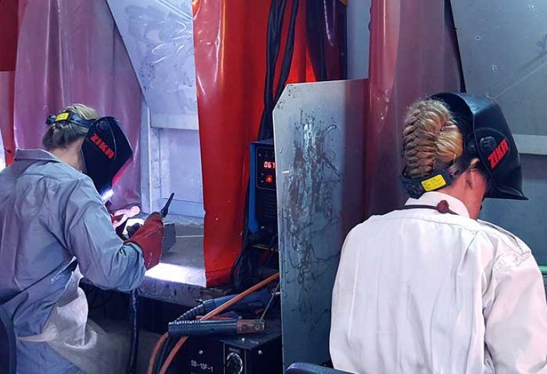 women practice at welding at the technological educational center